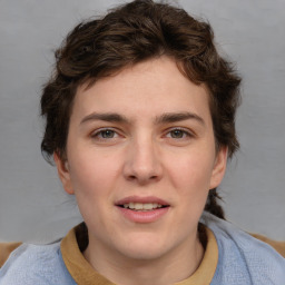 Joyful white young-adult female with medium  brown hair and blue eyes