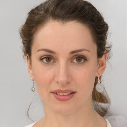 Joyful white young-adult female with medium  brown hair and green eyes