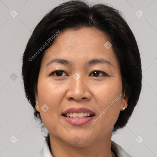 Joyful asian adult female with medium  brown hair and brown eyes