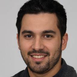 Joyful white young-adult male with short  black hair and brown eyes