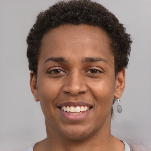 Joyful black young-adult female with short  brown hair and brown eyes