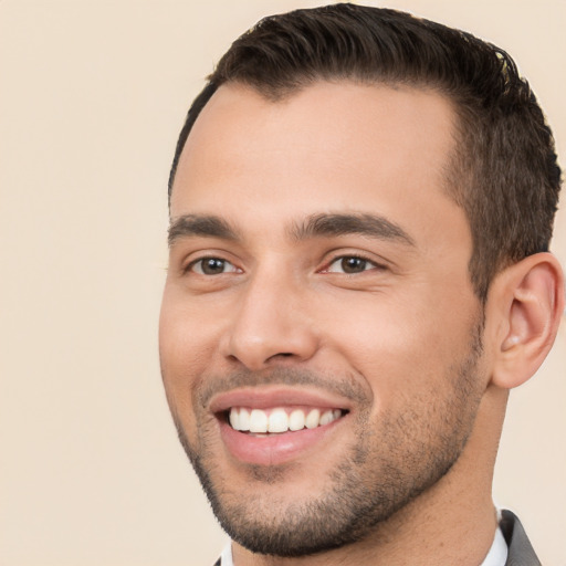 Joyful white young-adult male with short  brown hair and brown eyes