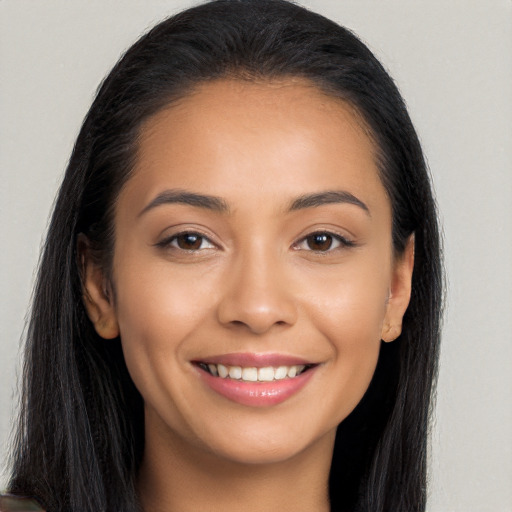 Joyful latino young-adult female with long  black hair and brown eyes