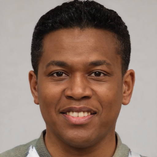 Joyful latino young-adult male with short  black hair and brown eyes