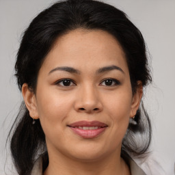 Joyful latino young-adult female with medium  brown hair and brown eyes