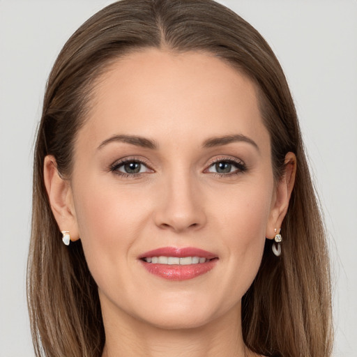 Joyful white young-adult female with long  brown hair and grey eyes