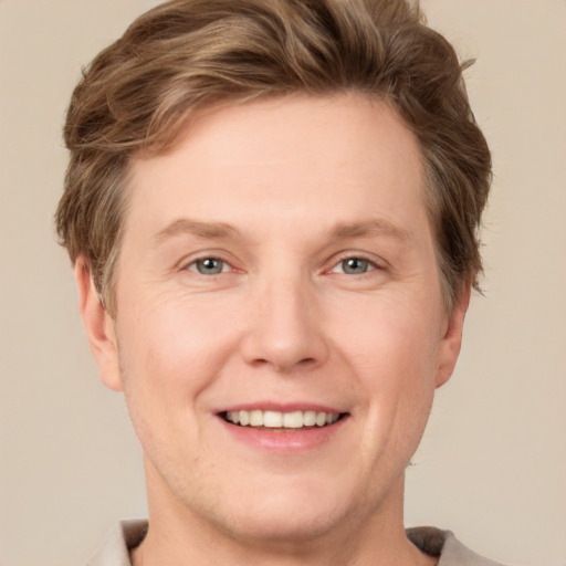 Joyful white adult male with short  brown hair and grey eyes