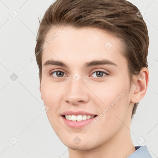 Joyful white young-adult male with short  brown hair and grey eyes