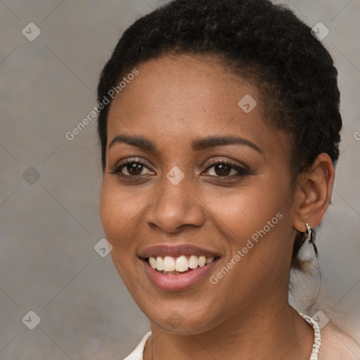 Joyful black young-adult female with short  brown hair and brown eyes