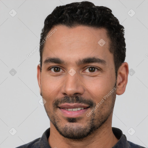 Joyful latino young-adult male with short  black hair and brown eyes