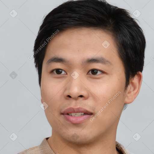 Joyful asian young-adult male with short  brown hair and brown eyes