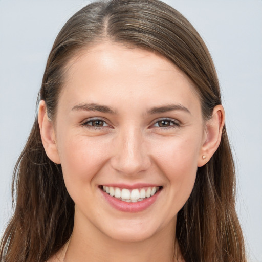 Joyful white young-adult female with long  brown hair and grey eyes