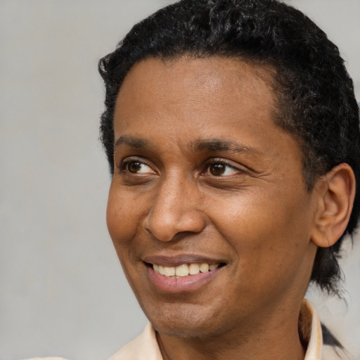 Joyful black adult male with short  brown hair and brown eyes