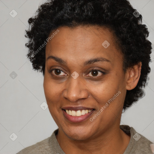 Joyful black adult female with short  brown hair and brown eyes