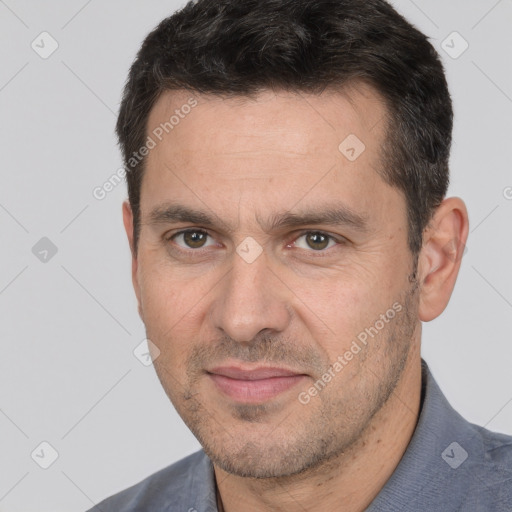 Joyful white adult male with short  brown hair and brown eyes