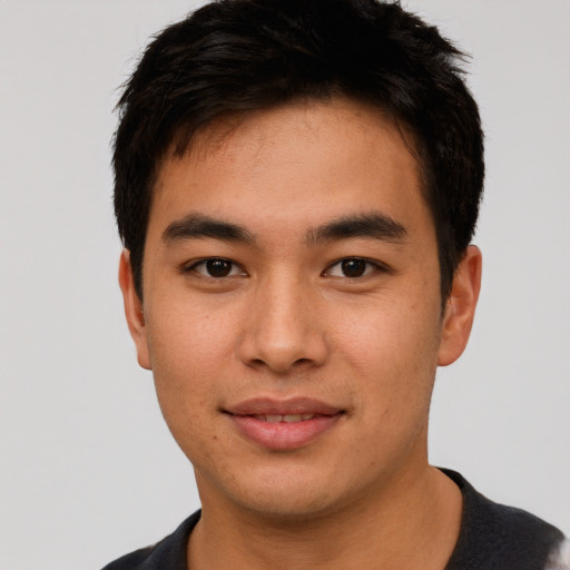 Joyful asian young-adult male with short  brown hair and brown eyes