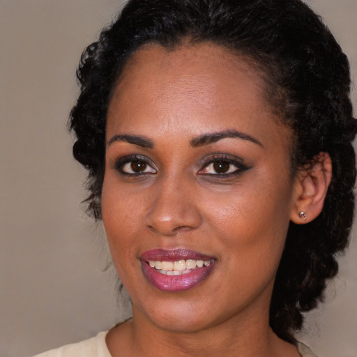 Joyful black young-adult female with medium  black hair and brown eyes