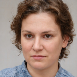 Joyful white young-adult female with medium  brown hair and blue eyes