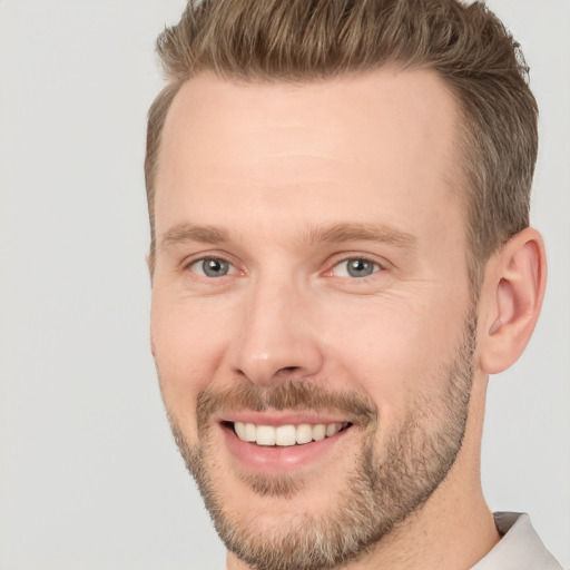 Joyful white adult male with short  brown hair and brown eyes