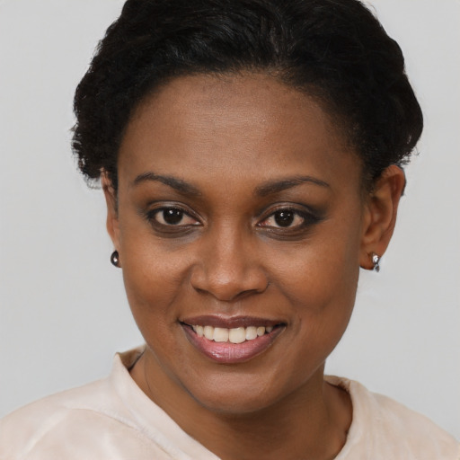 Joyful black young-adult female with short  brown hair and brown eyes