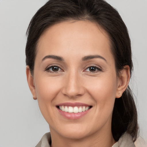 Joyful white young-adult female with medium  brown hair and brown eyes