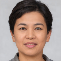 Joyful asian young-adult female with short  brown hair and brown eyes