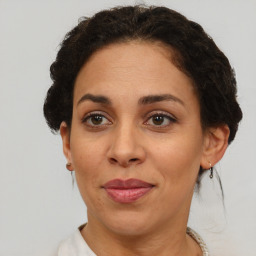 Joyful black adult female with short  brown hair and brown eyes