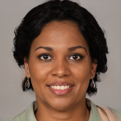 Joyful black young-adult female with medium  black hair and brown eyes