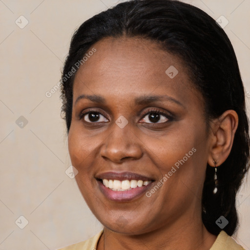 Joyful black adult female with medium  brown hair and brown eyes