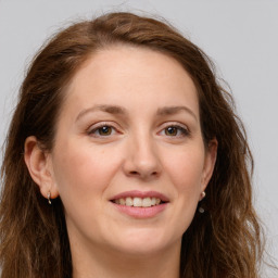 Joyful white young-adult female with long  brown hair and green eyes