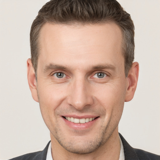 Joyful white adult male with short  brown hair and brown eyes