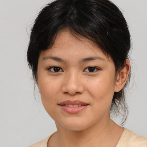 Joyful asian young-adult female with medium  brown hair and brown eyes