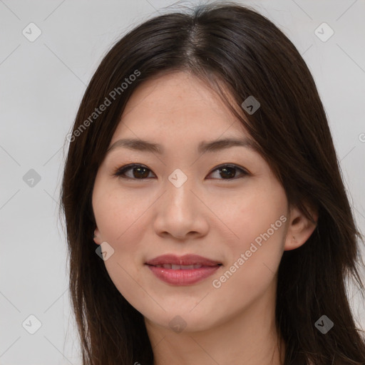 Joyful asian young-adult female with long  brown hair and brown eyes