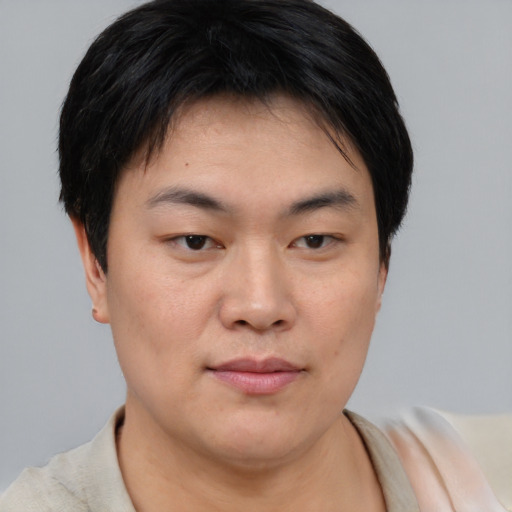 Joyful asian young-adult male with short  brown hair and brown eyes