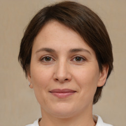 Joyful white adult female with medium  brown hair and brown eyes