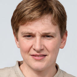 Joyful white adult male with short  brown hair and grey eyes