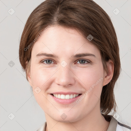 Joyful white young-adult female with medium  brown hair and grey eyes