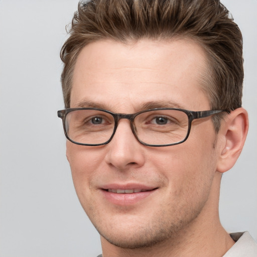 Joyful white adult male with short  brown hair and grey eyes