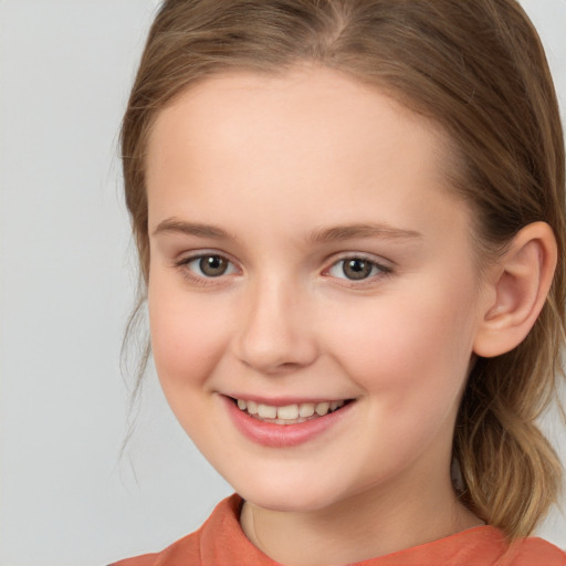 Joyful white child female with medium  brown hair and brown eyes