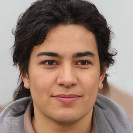 Joyful latino young-adult male with medium  brown hair and brown eyes