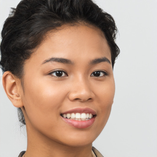 Joyful latino young-adult female with short  brown hair and brown eyes