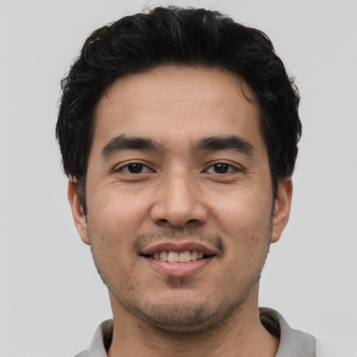 Joyful asian young-adult male with short  black hair and brown eyes