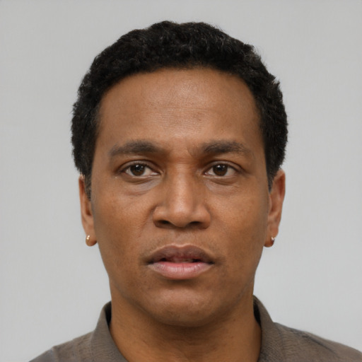 Neutral latino adult male with short  black hair and brown eyes