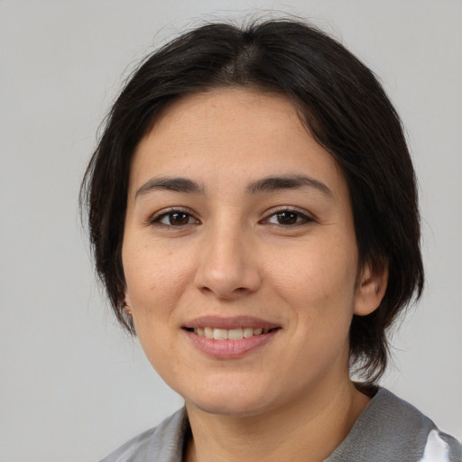 Joyful asian young-adult female with medium  brown hair and brown eyes