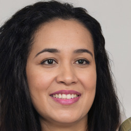 Joyful latino young-adult female with long  brown hair and brown eyes