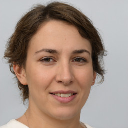 Joyful white adult female with medium  brown hair and brown eyes