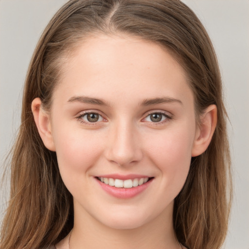 Joyful white young-adult female with long  brown hair and grey eyes