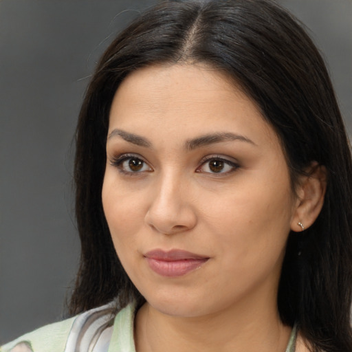 Joyful latino young-adult female with long  brown hair and brown eyes