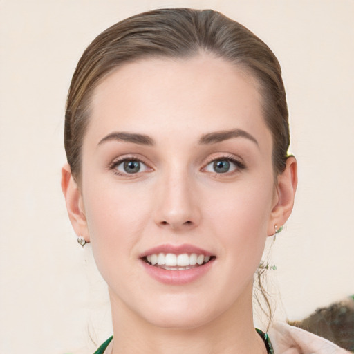 Joyful white young-adult female with medium  brown hair and green eyes