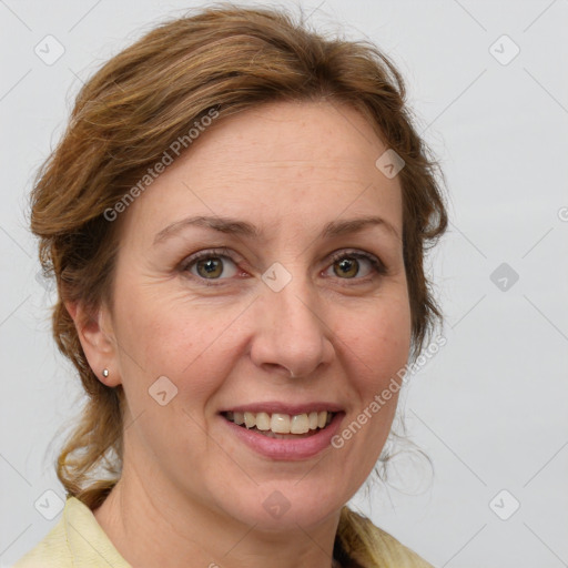 Joyful white adult female with medium  brown hair and blue eyes